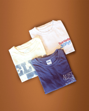 Load image into Gallery viewer, nativegood thrifted t shirt bundle (3 shirts) on an orange background