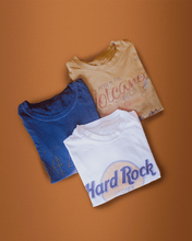 Load image into Gallery viewer, nativegood thrifted t shirt bundle (3 shirts) on an orange background
